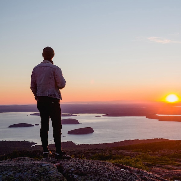 Hiker on top of Cadillac Mountain of Acadia National Park in Bar Harbor, Maine