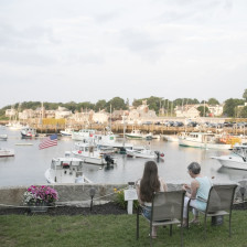 Two women looking at boats in Rockport Habor in Massachusetts