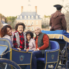 Family on a horse-drawn carriage ride of Colonial Williamsburg in Virginia