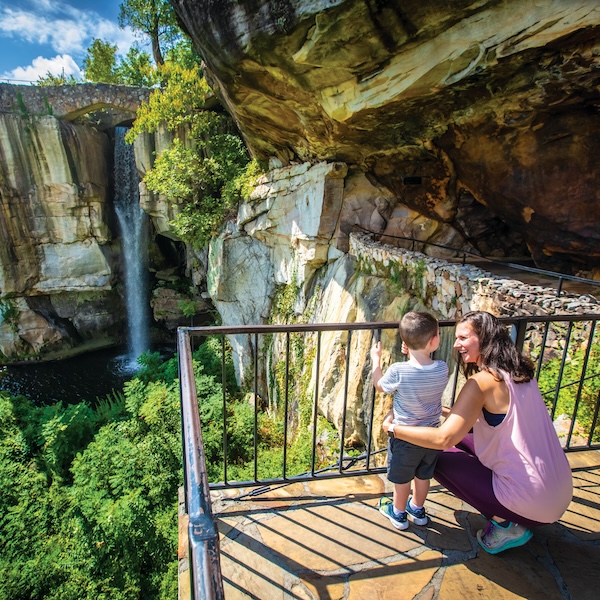Mom and son overlooking a waterfall at Rock City in Lookout Mountain, Georgia