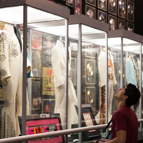 Visitor admiring a display at Graceland: The Home of Elvis Presley in Memphis, Tennessee