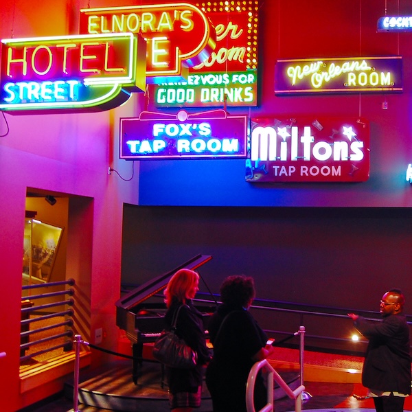 Visitors admiring the neon light display at the American Jazz Museum in Kansas City, Missouri
