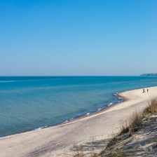 Visitors walking the coast of Lake Michigan in Indiana Dunes National Park