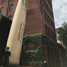 Man in front of the Louisville Slugger Museum & Factory in Louisville, Kentucky