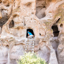 Visitor exploring an ancestral pubelo in Bandelier National Monument in Los Alamos, New Mexico
