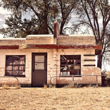 An abandoned building and car in the Glenrio Ghost Town at the border of New Mexico and Texas